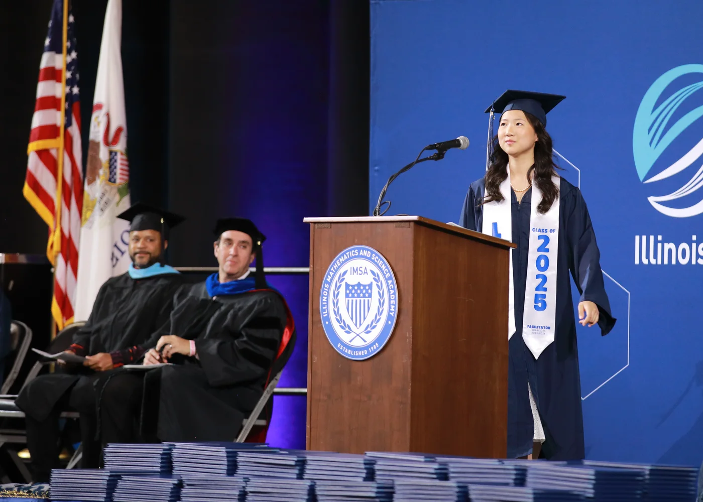 Carissa Chen speaking at a graduation podium
